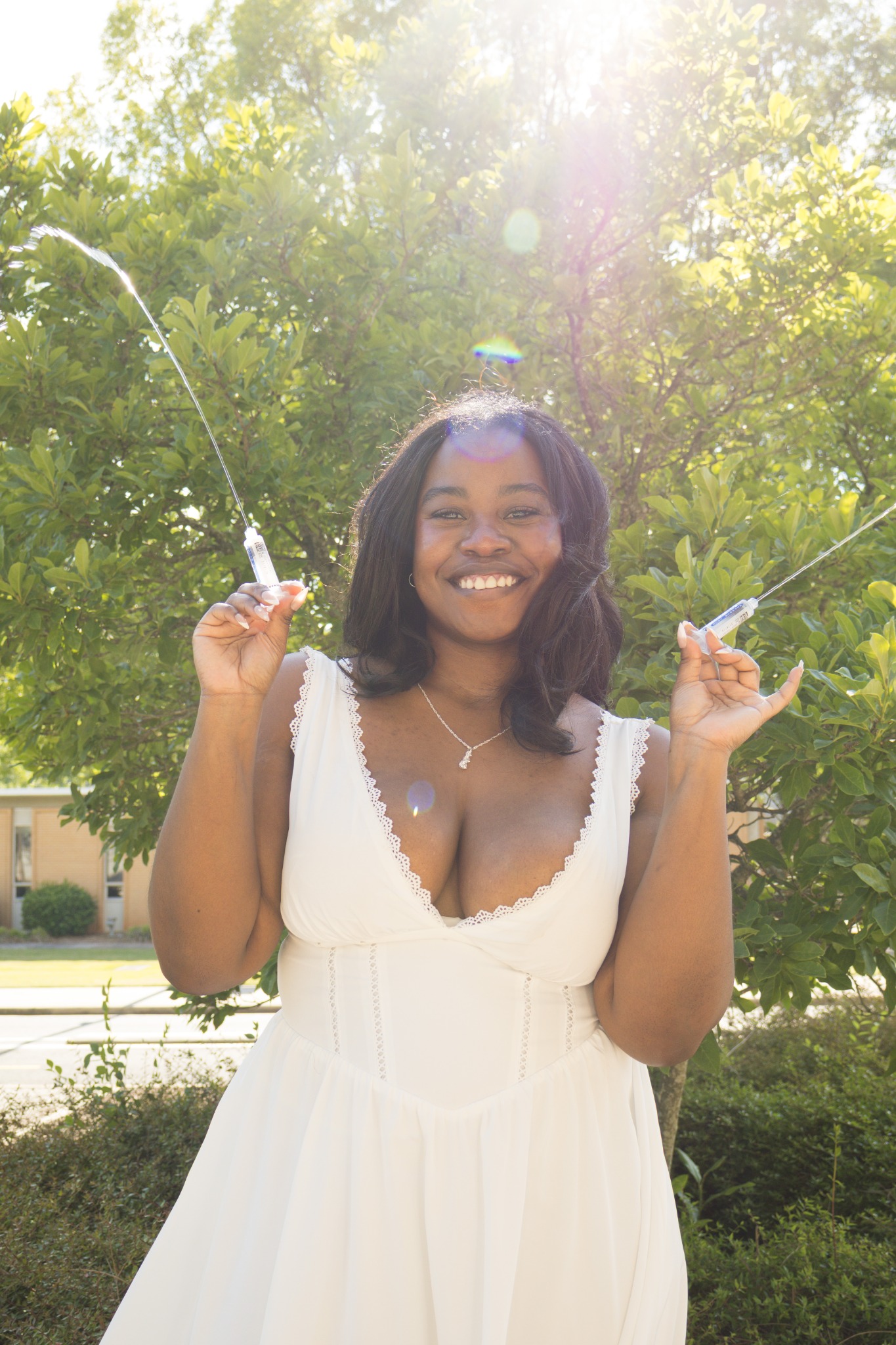 Bright outdoor graduation portrait with sunlight